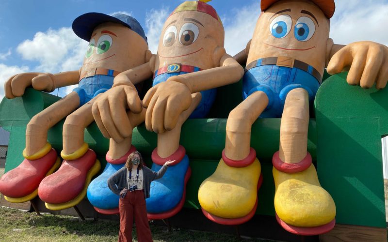 Sara Schleede poses at a roadside attraction of giant couch potatoes